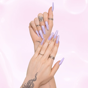 Two hands wearing lilac holographic glitter, long coffin shape press on nails by Scandal Beauty