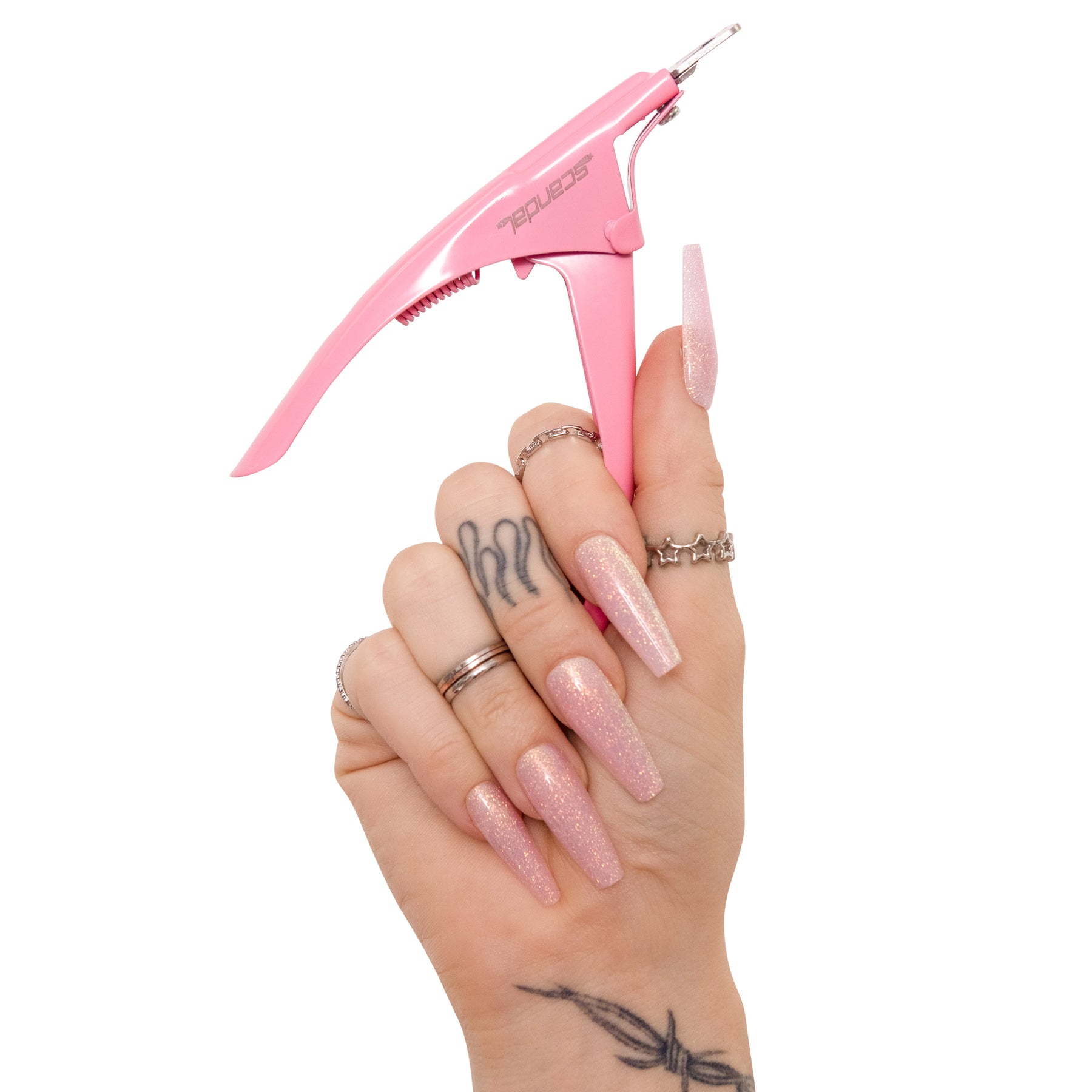 Hand holding pink stainless steel acrylic nail clippers gently and effectively cut artificial nails. Regular nail clippers or scissors may crack, split or damage your press-on nails. Our high quality clippers feature an extremely sharp blade, designed to safely and easily cut the nail tips. 